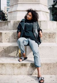 Portrait of young woman sitting on steps