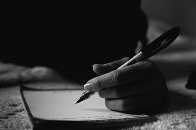 Close-up of hand holding paper