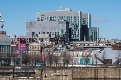 Buildings in city against clear sky