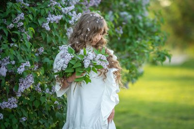 Rear view of woman standing against white wall