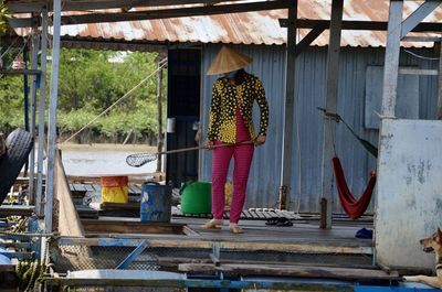 Rear view of woman working on building