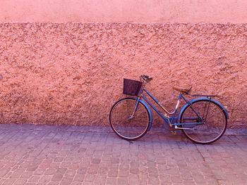 Bicycle parked on wall