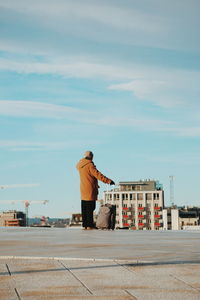 Rear view of man standing on road