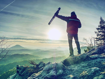 Man photographer taking picture of landscape when sunrise at mountain peak.travel hobbies concept