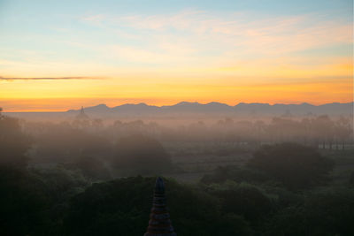 Scenic view of landscape against sky during sunset