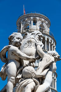 Low angle view of statue against blue sky