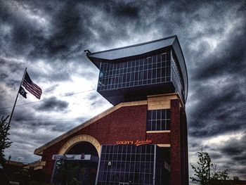 Low angle view of building against cloudy sky