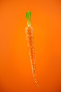 Close-up of pumpkin against orange background