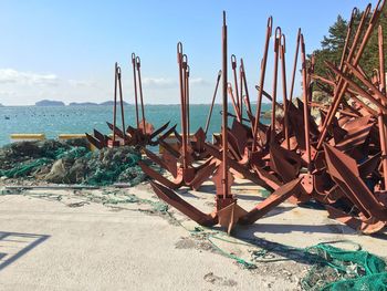 Abandoned boats on beach against sky