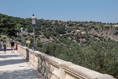 A path in the garden of ragusa ibla runs along the ravine with its view of the hills