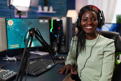 Portrait of podcaster sitting in studio