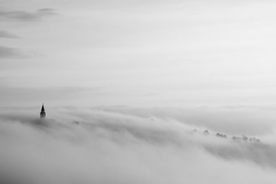 Scenic view of building against foggy sky