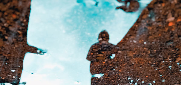 High angle view of woman standing by swimming pool