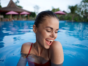 Young woman smiling in swimming pool