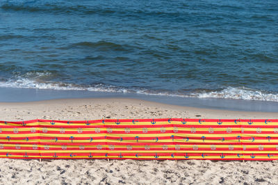 Bbeach screen on the polish beach on a sunny summer day in the background beautiful sea.