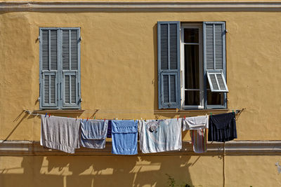 Low angle view of clothes drying against building