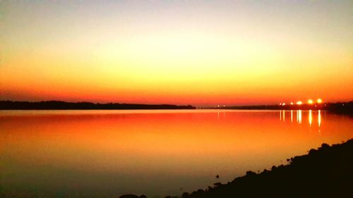 Scenic view of lake against romantic sky at sunset