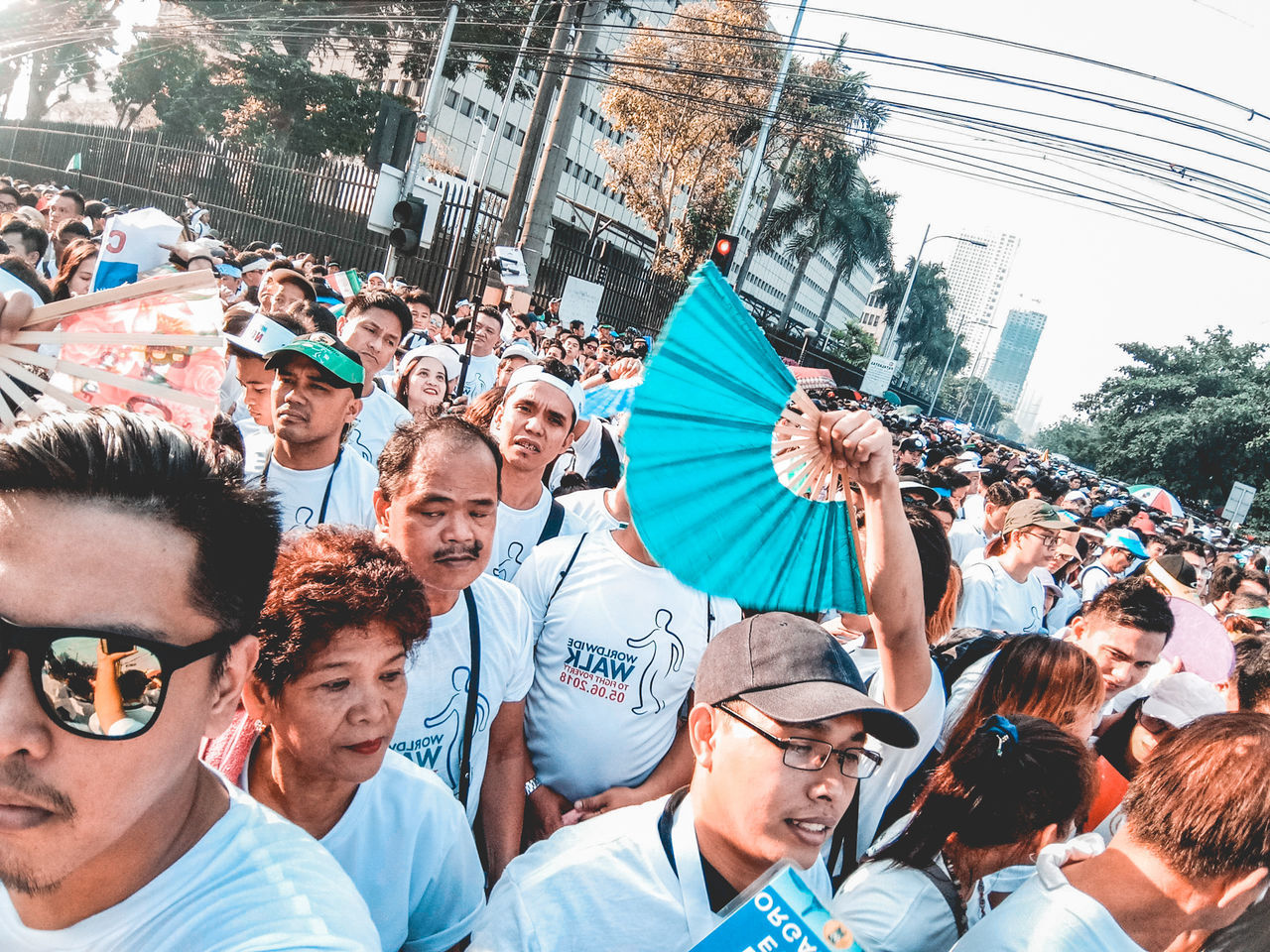 crowd, group of people, large group of people, real people, architecture, city, men, day, togetherness, women, adult, lifestyles, street, watching, built structure, building exterior, looking, happiness, leisure activity, spectator, outdoors, arms raised, excitement