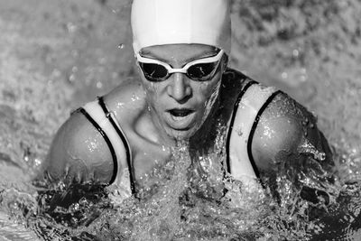 Close-up of woman swimming in pool