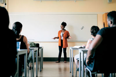 Teacher teaching language to students in classroom