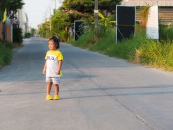 Portrait of boy standing on road