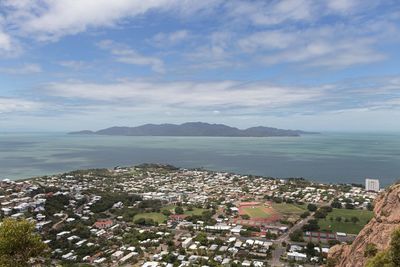 High angle view of townscape by sea against sky