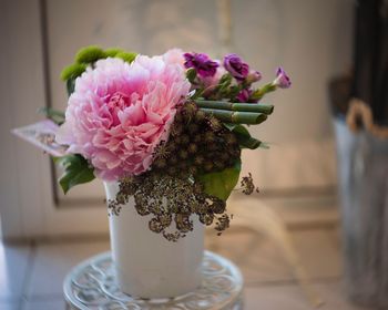 Close-up of pink rose flower vase on table