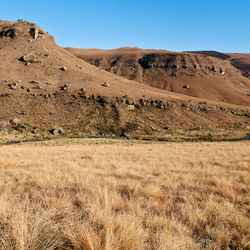 Scenic view of arid landscape against clear sky