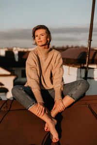 Portrait of a smiling young woman sitting outdoors