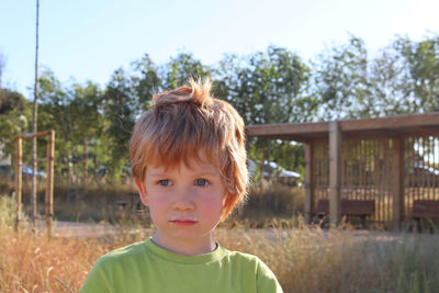 A blond boy with a milky mustache looks thoughtfully into the distance. serious five-year-old boy 