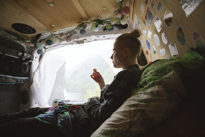 Woman relaxing in camper van