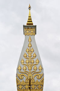 Low angle view of cross against sky