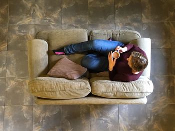 Young woman relaxing on sofa