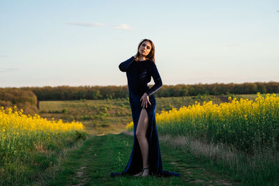 Full length of woman standing on field