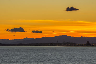 Scenic view of sea against orange sky