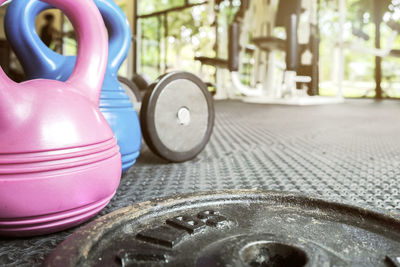 Close-up of dumbbell plates and kettlebells in gym