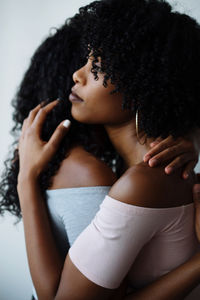 Portrait of two women of color hugging each other