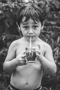 Close-up portrait of boy holding water