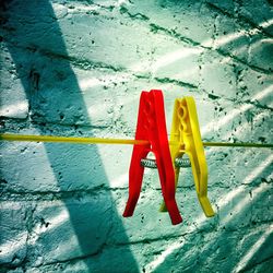 Close-up of clothes drying against wall