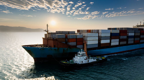 Container ship transporting large cargo logistic import export goods internationally worldwide 