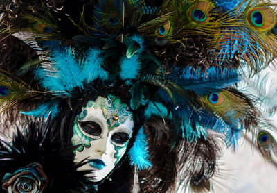 Close-up portrait of woman wearing venetian mask