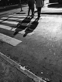 Low section of people walking on road