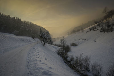 Scenic view of snow covered mountains against sky