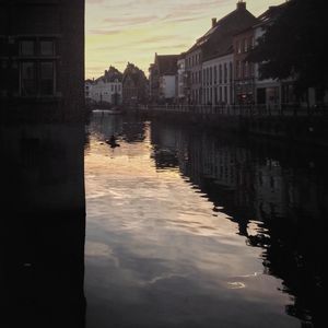 Reflection of buildings in city against sky