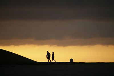 Silhouette of woman at sunset