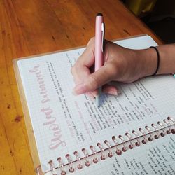 High angle view of woman reading book on table