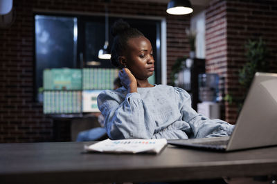 Young woman using laptop at office