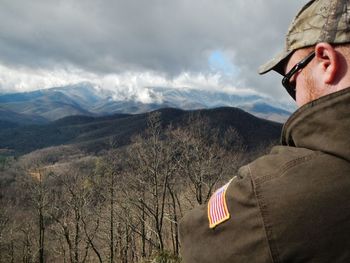 Scenic view of mountains against cloudy sky