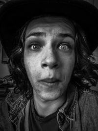 Close-up portrait of young man wearing hat