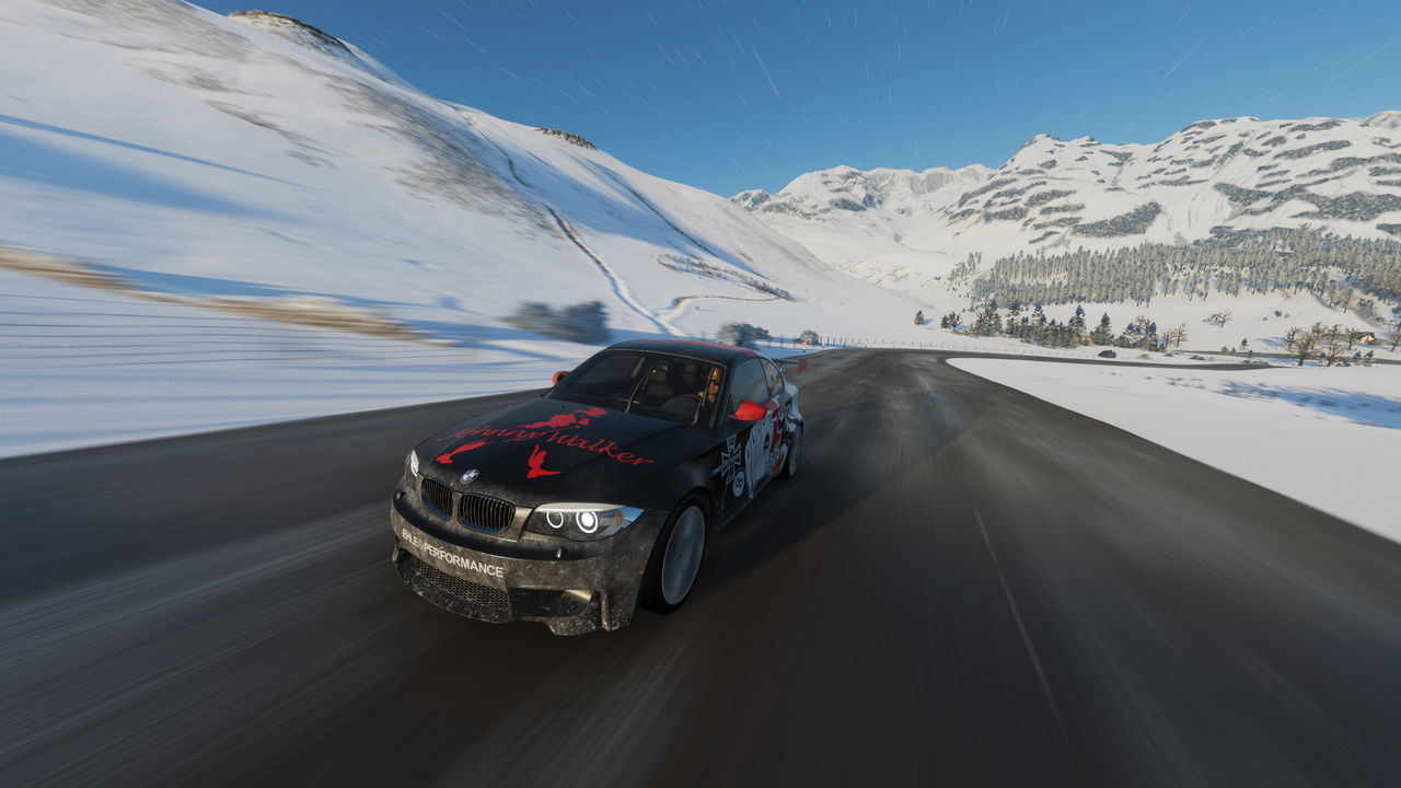 CAR ON ROAD AGAINST SNOWCAPPED MOUNTAINS